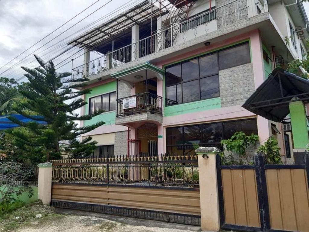 a house with a fence in front of it at A's Azotea de Bohol in Tagbilaran City