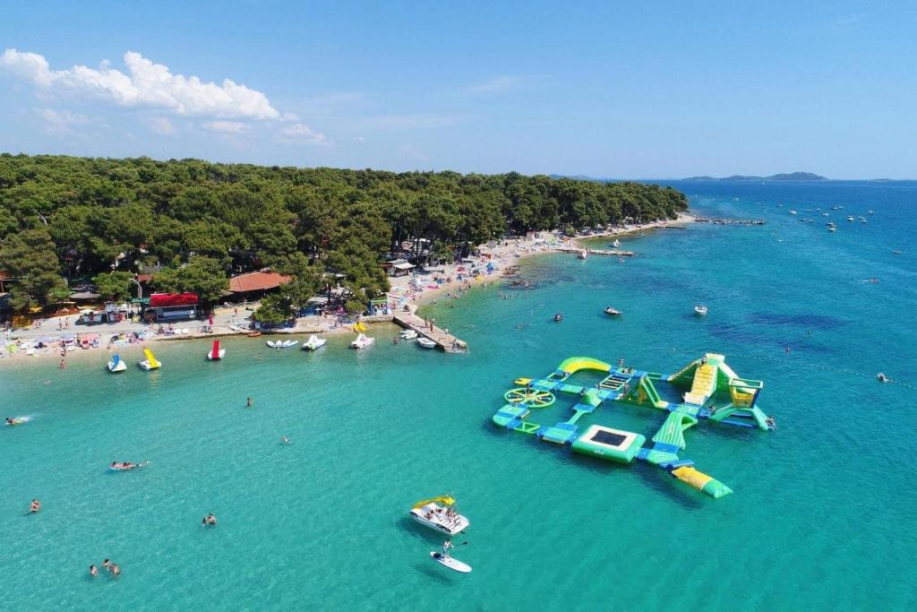 an aerial view of a beach with a water slide at Bajki Mobile home in Biograd na Moru