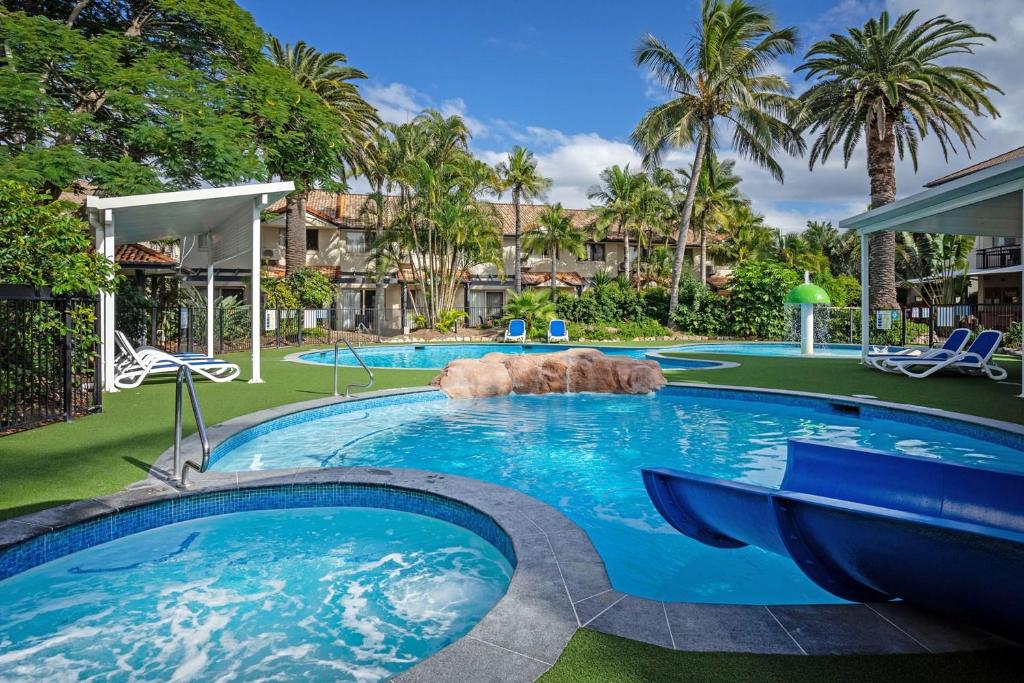 a large swimming pool with a dog laying in it at BEST Ground Floor pool side Superior apartment - new listing in Gold Coast