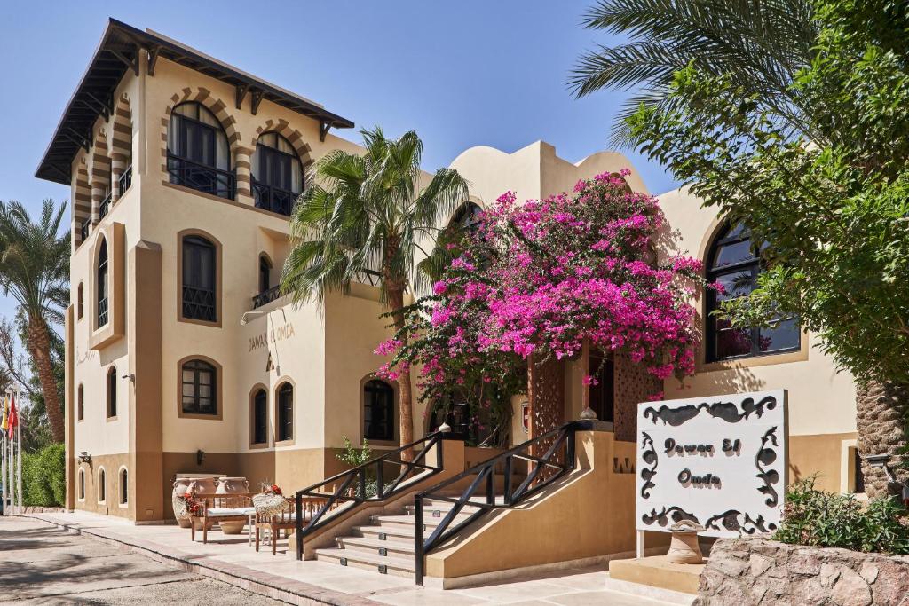 a building with pink flowers on the side of it at Dawar El Omda (Adults Only) in Hurghada