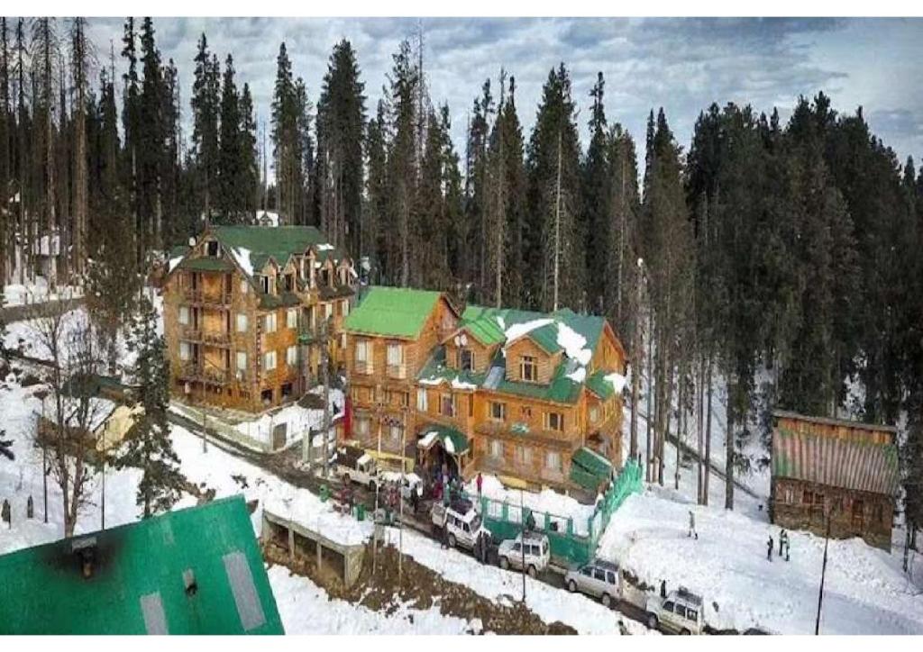 a large house with a train in the snow at hotel khalil in Gulmarg