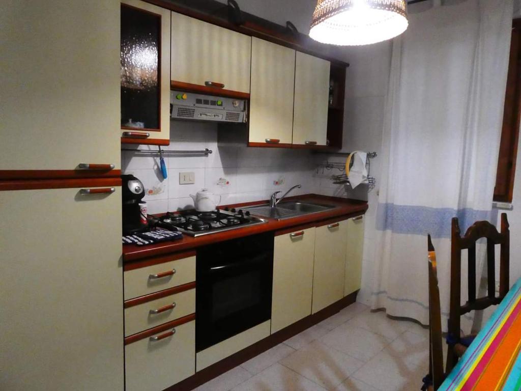 a small kitchen with a stove and a sink at Casa Lore al mare in Santa Lucia