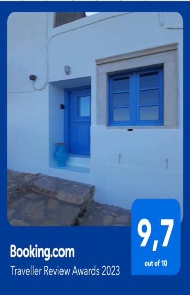 a picture of a house with a blue door at BAROS VIEW in Apérathos