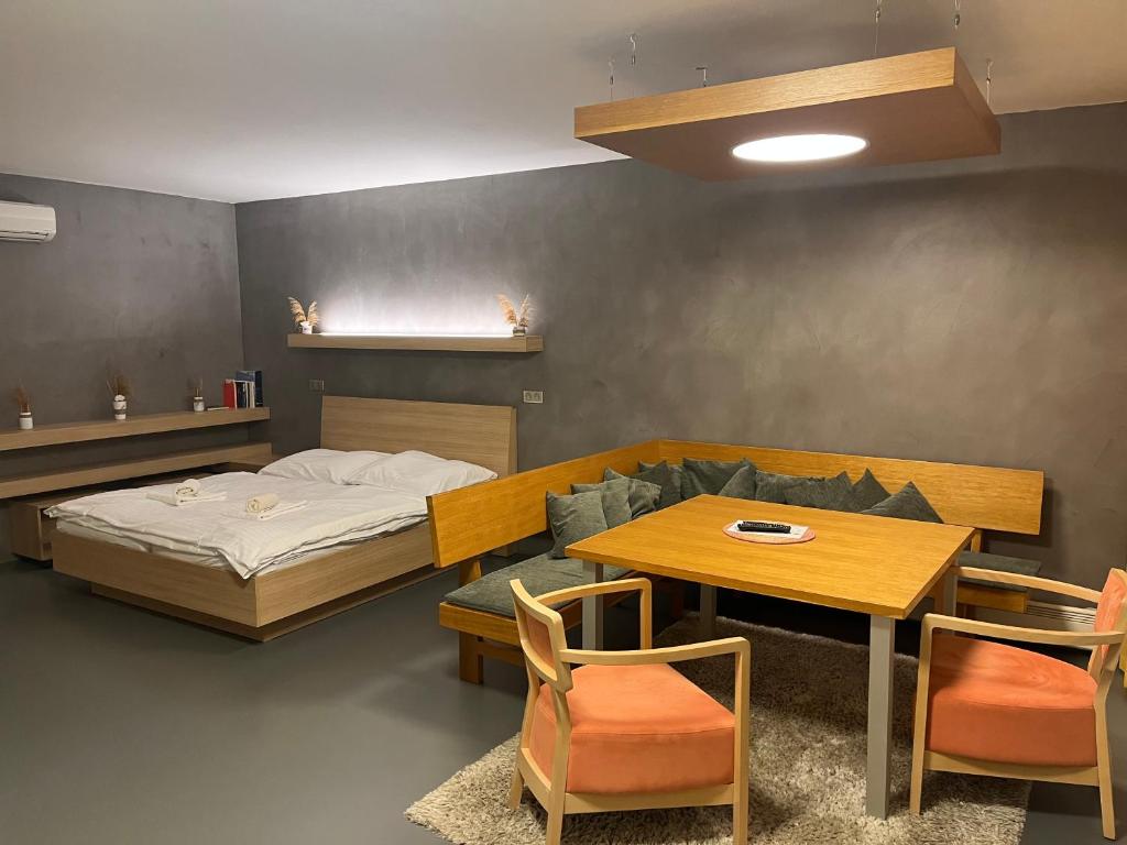 a bedroom with a bed and a table and chairs at Palava eu 11 in Pavlov