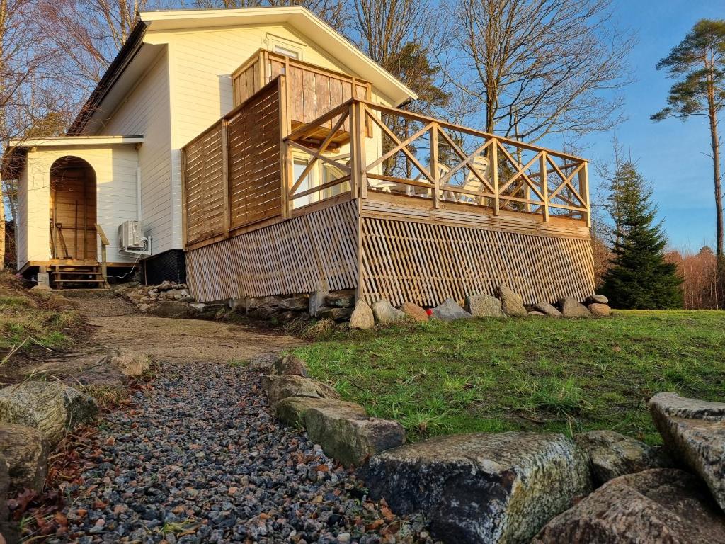 a house with a large deck on the side of it at Orust East Coast Villa in Stillingsön