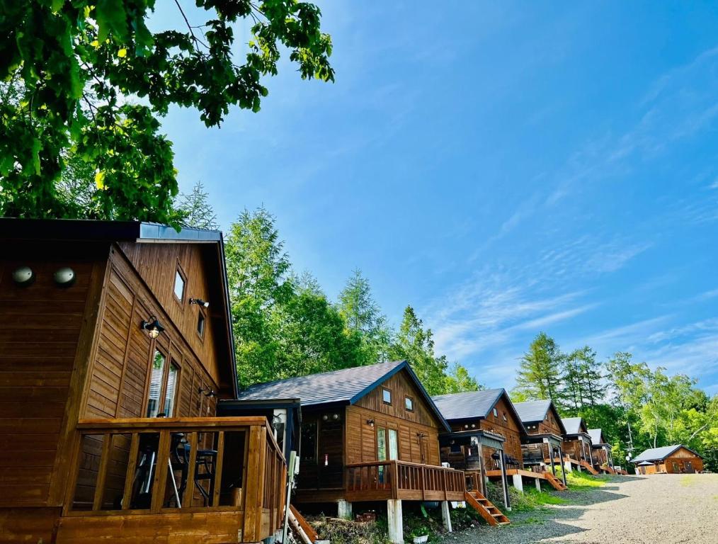 a row of wooden cabins in a row at Shirakaba no mori Cottage - Vacation STAY 55195v in Abashiri