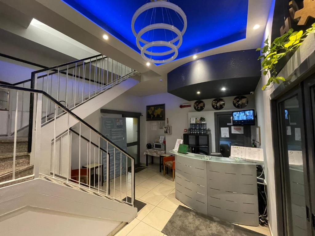 an office with a staircase and a lobby with a desk at Hotel Convertini in Milan