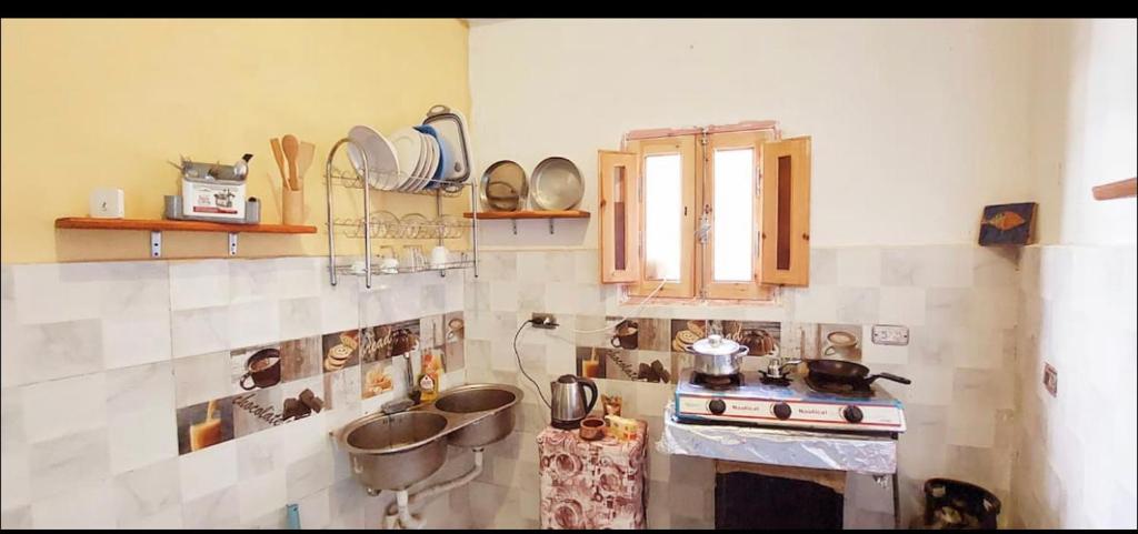 a kitchen with a stove and a bunch of pots and pans at Dahab in Dahab