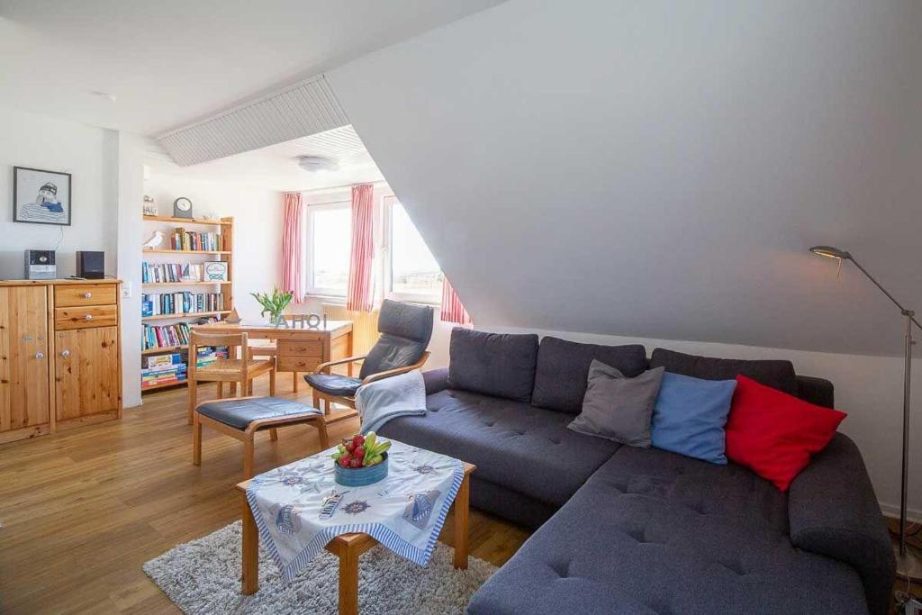 a living room with a couch and a table at Ahoi in Norddorf