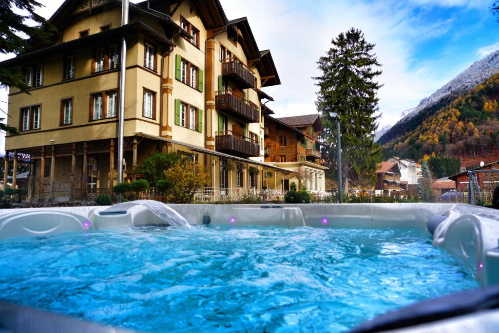a hot tub in front of a hotel at Alpenrose Hotel and Gardens in Wilderswil