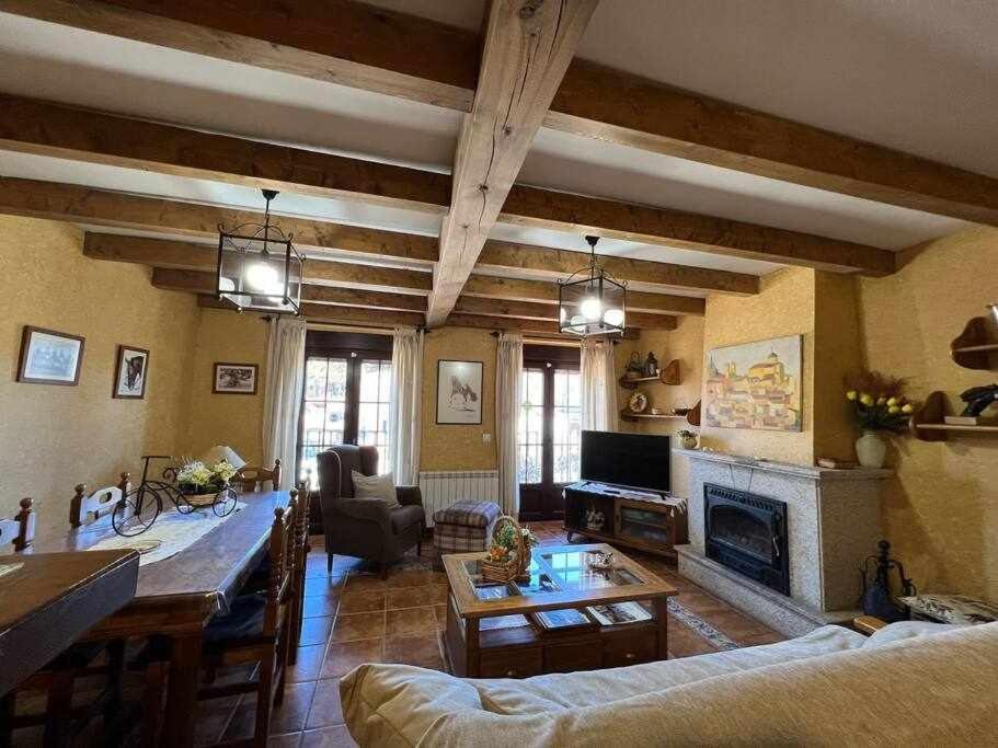 a living room with a couch and a fireplace at El Sobrao de Gredos in Navarredonda de Gredos