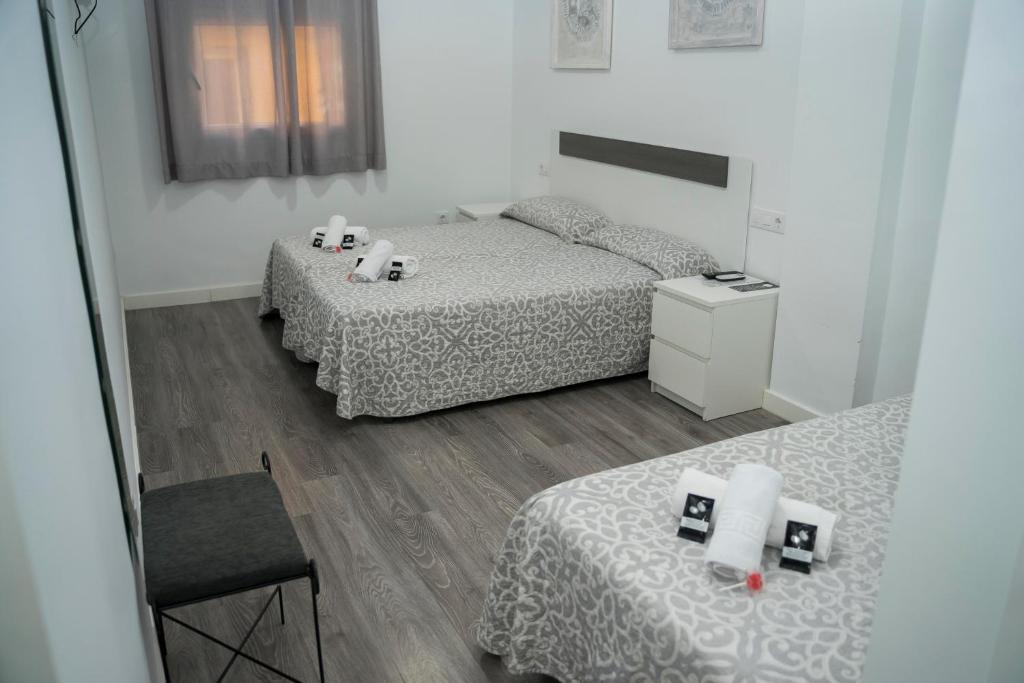 Cama o camas de una habitación en Hostal Goyesco Plaza