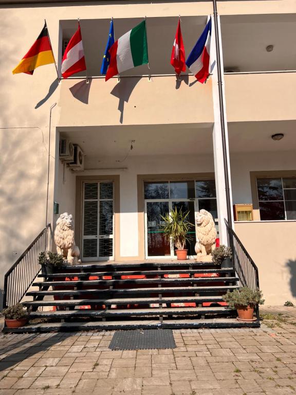 a house with flags on the front of it at Hotel Saratoga in Vigevano
