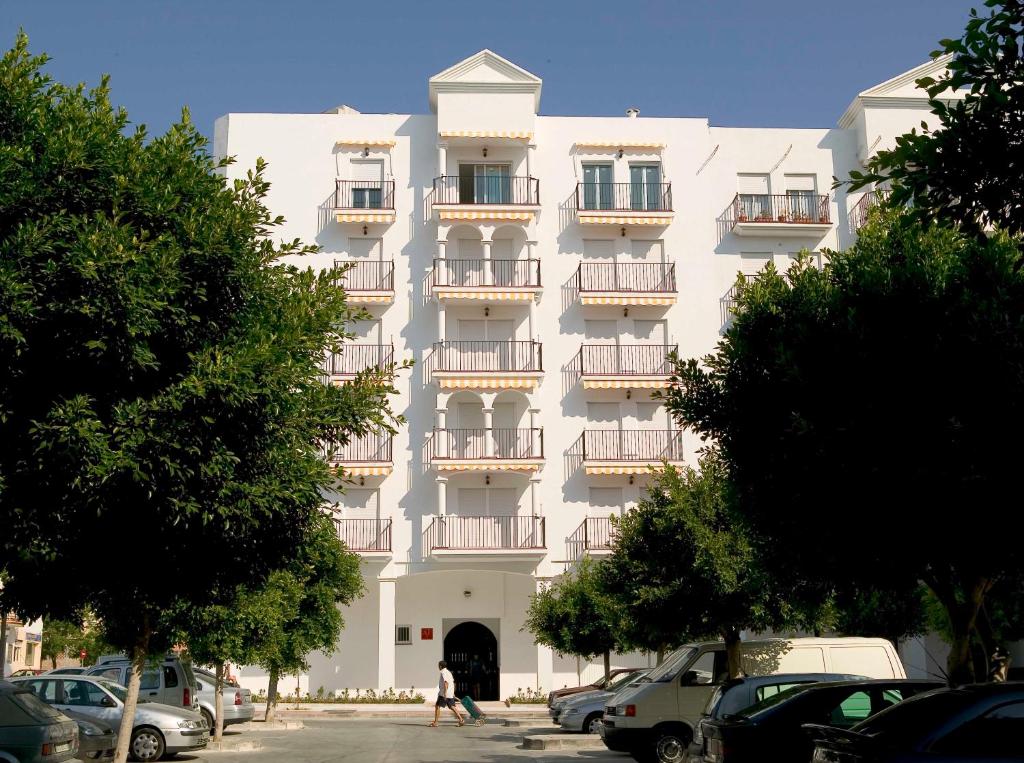 a large white building with balconies on it at Apartamentos Miguel Angel in Estepona