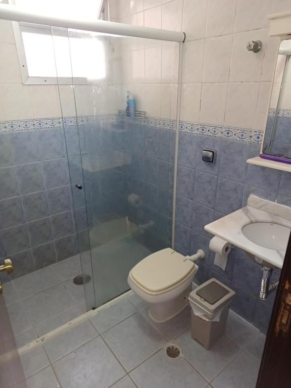 een badkamer met douche, toilet en wastafel bij Praia Grande Boqueirão e Guilhermina in Praia Grande