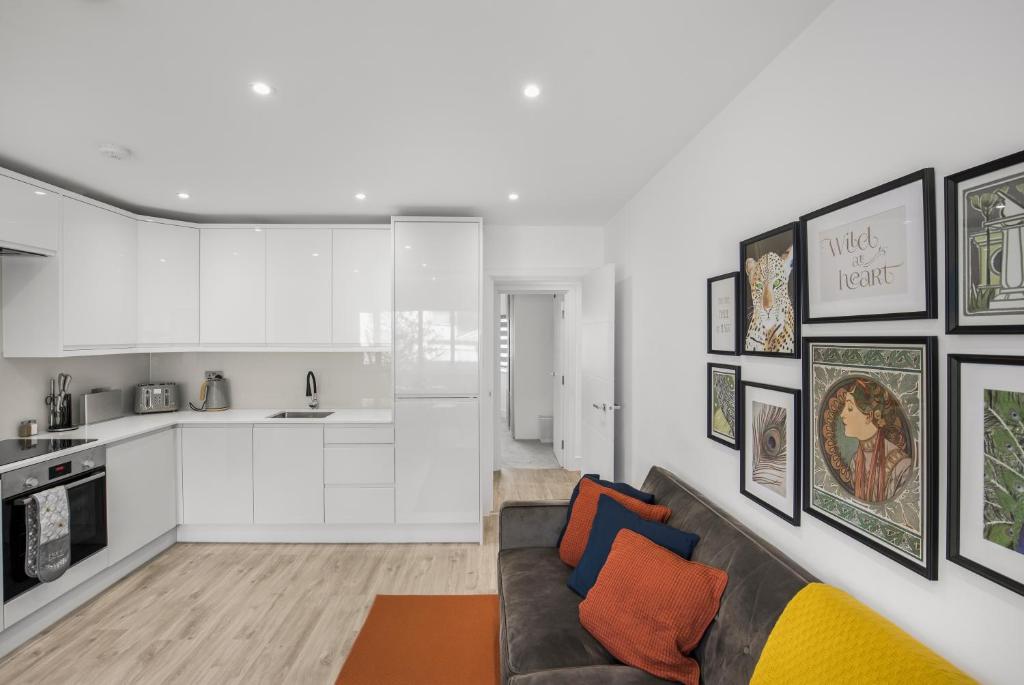 a living room with a couch and a kitchen at Star London Vivian Avenue 2- Bed Abode in The Hyde