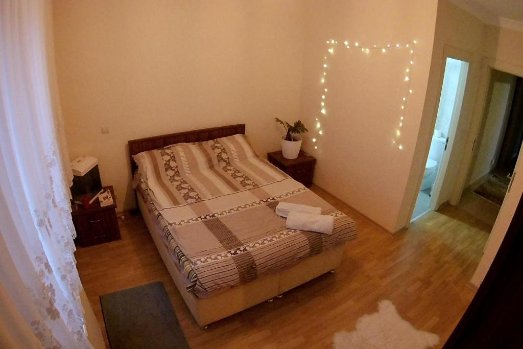a bedroom with a bed with lights on the wall at Private Room in Istanbul #45 in Tuzla