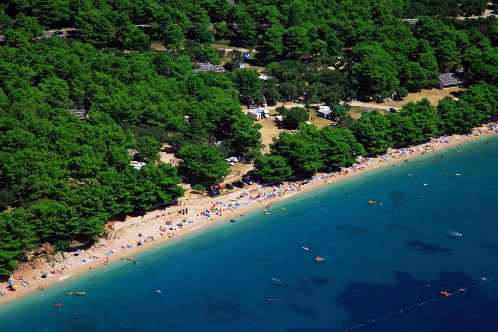 an overhead view of a beach with people in the water at Glamping & Holiday Home experience - Camp Dole in Živogošće