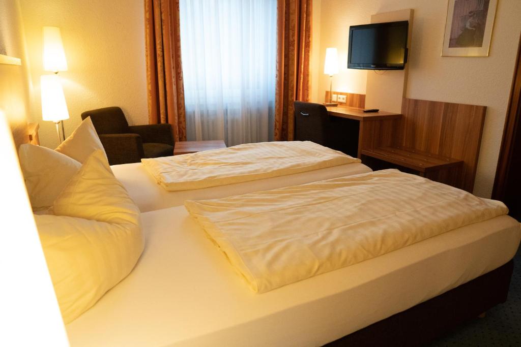 Postel nebo postele na pokoji v ubytování Hotel Jägerhof
