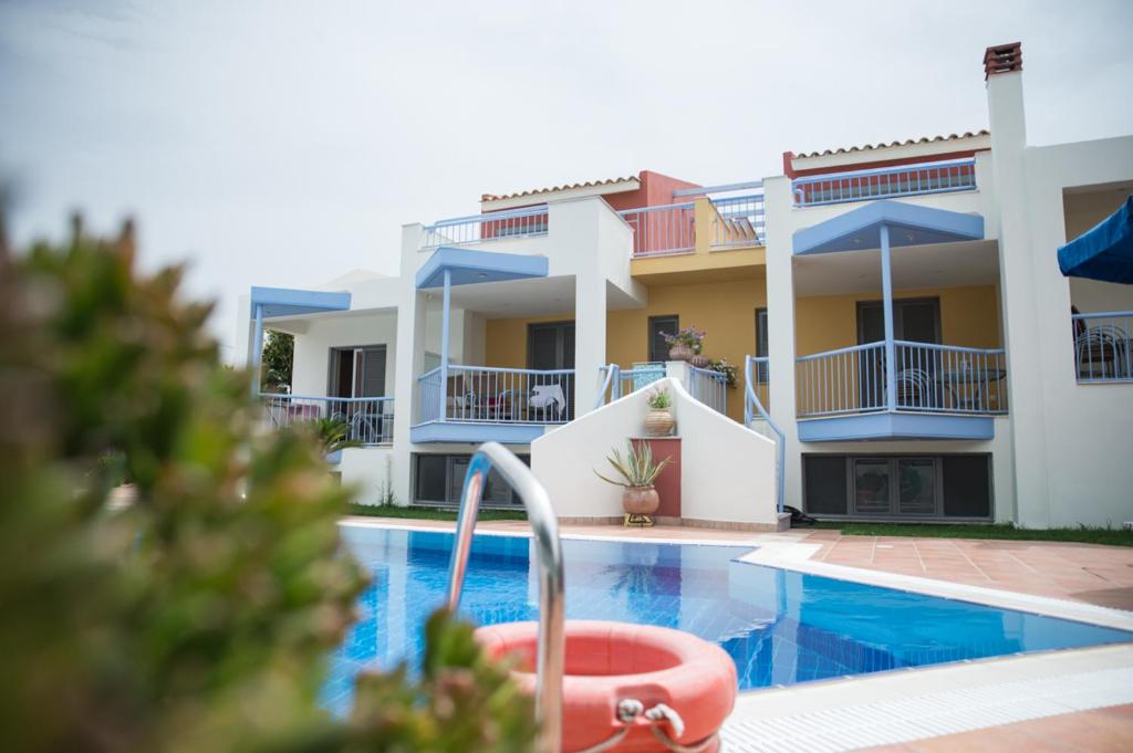 a villa with a swimming pool in front of a house at Niriides in Kyparissia