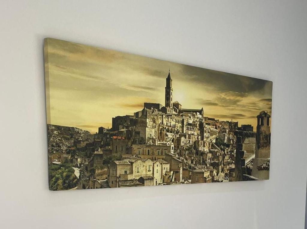 a painting of a city with a church on top at Be Home in Matera