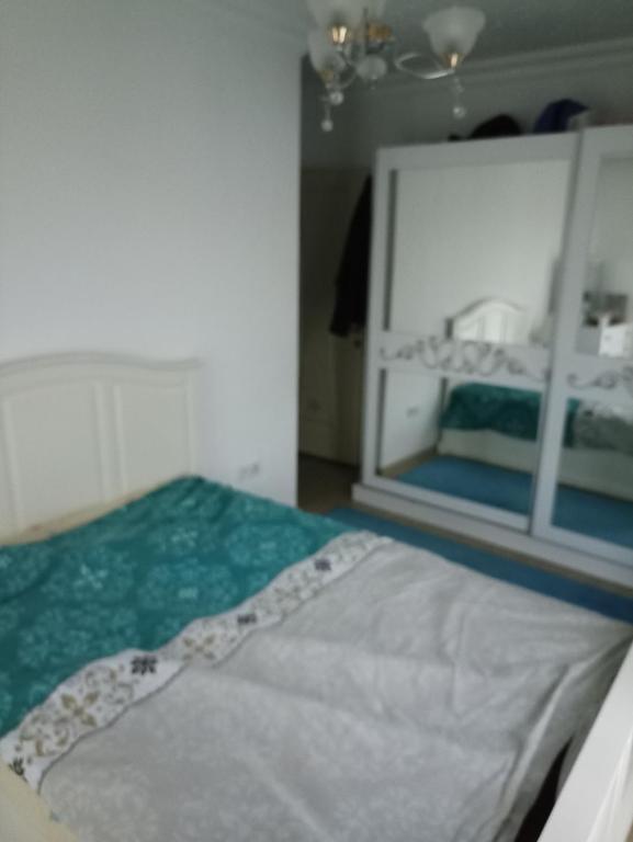 a bedroom with a bed with a large mirror at Private Room in Istanbul #49 in Tuzla