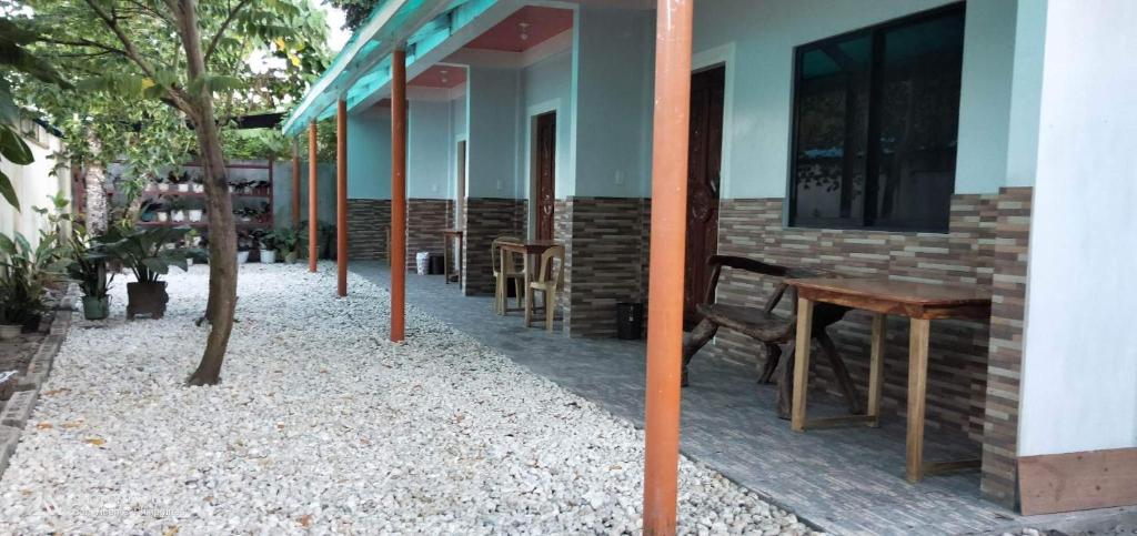a row of tables and chairs outside of a building at Dhong and Eden Home in San Vicente