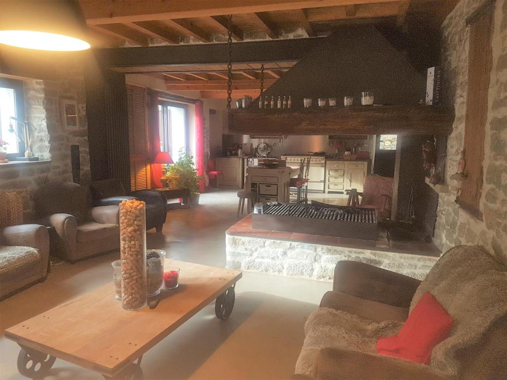 a living room with a couch and a table at Villa Misanid écrin de verdure à 15mm de la cité de Carcassonne in Mas-des-Cours