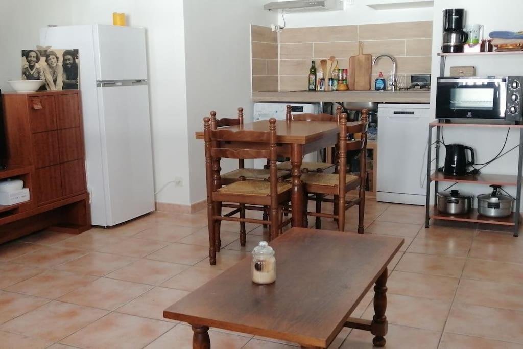 a kitchen with a table and chairs and a refrigerator at T2 6 couchages. Plein centre in Ax-les-Thermes