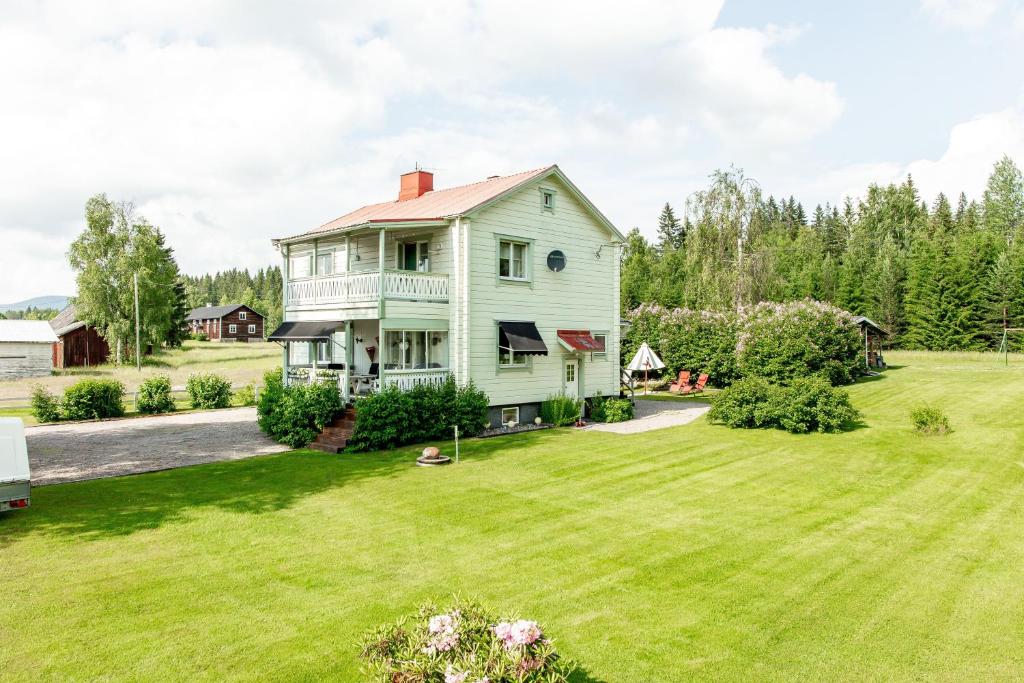 an image of a house with a yard at Guestrooms at Forest Family Home in Ytterhogdal