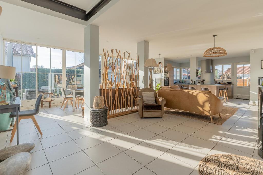 a living room with a couch and a table at Magnifique maison avec piscine a Gujan-Mestras in Gujan-Mestras