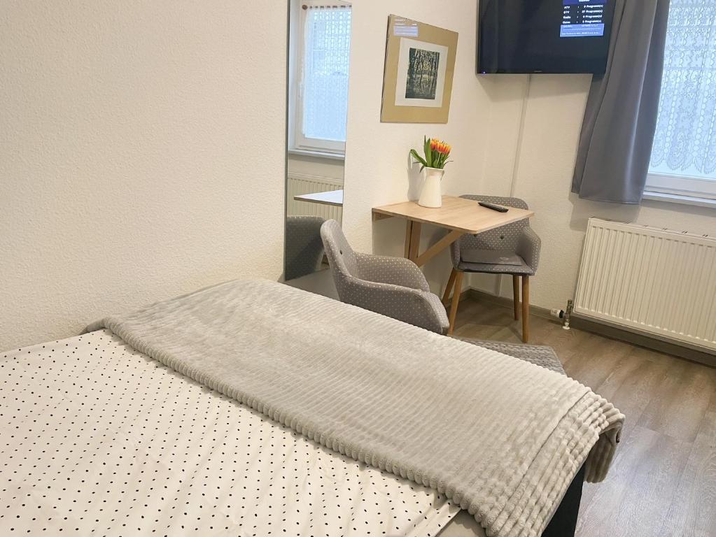 a hospital room with a bed and a desk at Ferienzimmer Adalonia in Greifswald