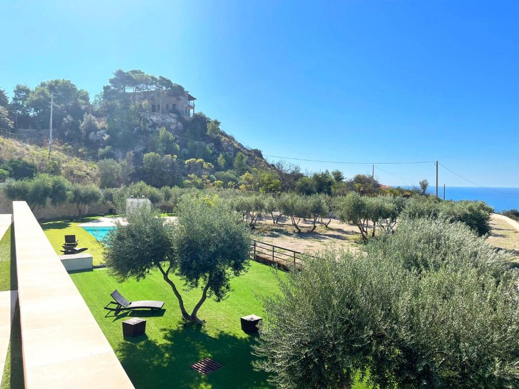 a view of a garden with trees and a hill at Daedalium in Marina di Palma