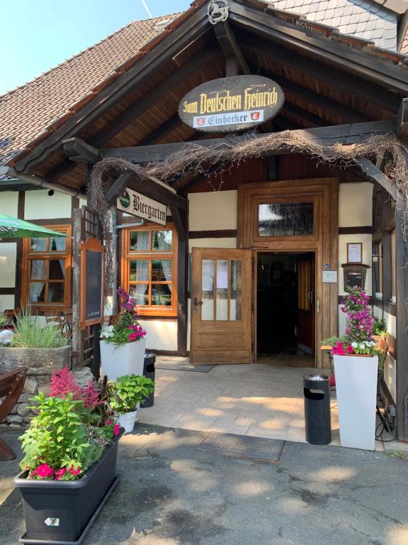 吉夫霍恩的住宿－Zum Deutschen Heinrich，前方鲜花盛开的餐厅入口