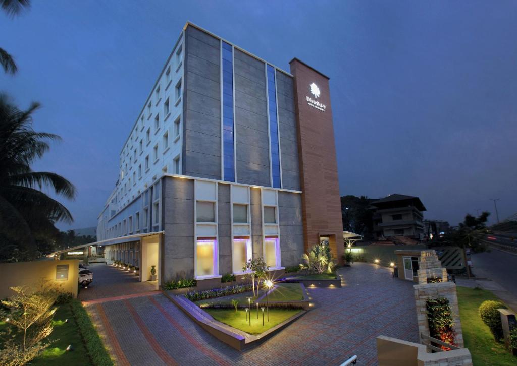 a tall building with a sign on the side of it at Distrikt 9 in Palakkad