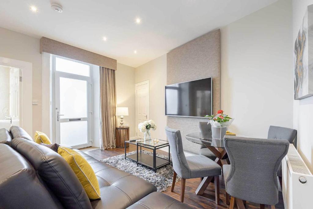 a living room with a couch and a table at Craignish Apartments in Falkirk