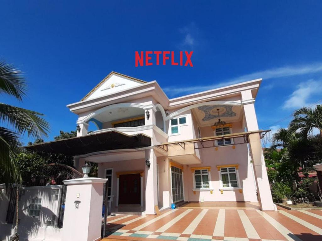 a white house with the words netflix on it at Homestay Banglo Alor Setar in Alor Setar