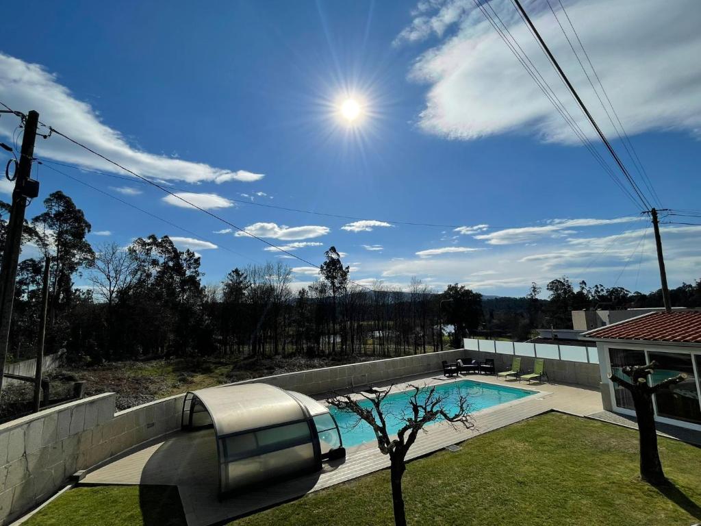a swimming pool on the roof of a house at Ucha Villa in Barcelos