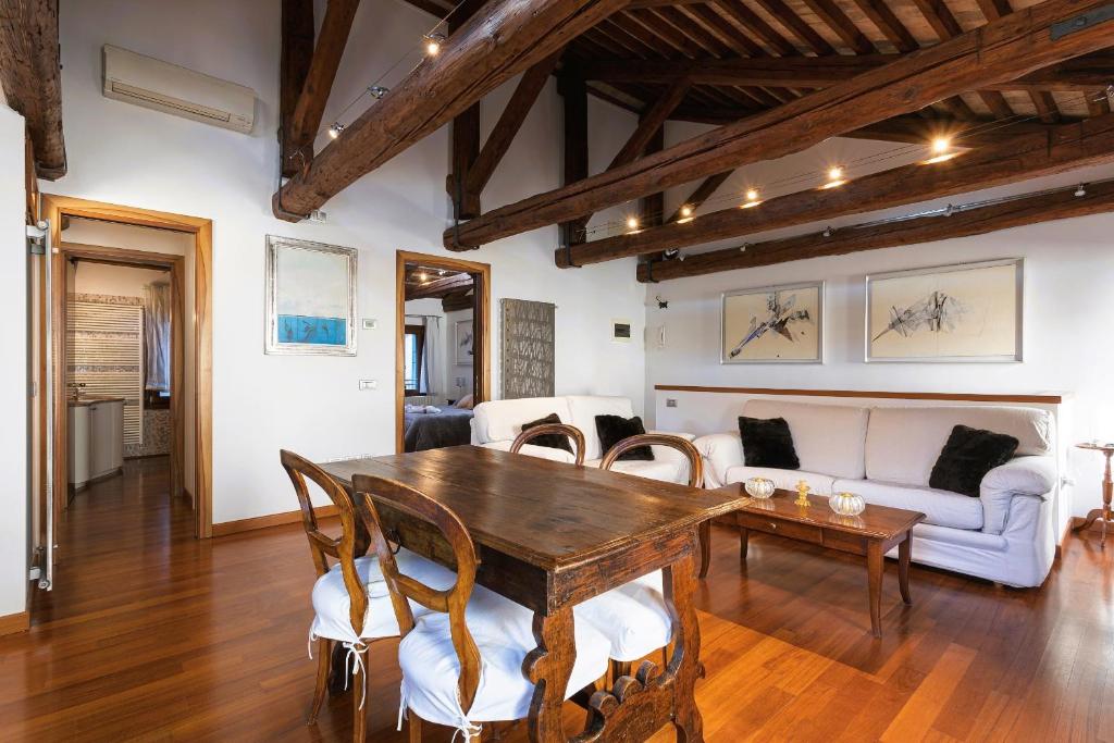 a living room with a wooden table and a couch at San Marco Luxury Loft with Terrace in Venice