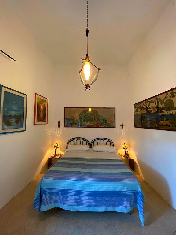 Postel nebo postele na pokoji v ubytování Palazzo Sabella Tommasi