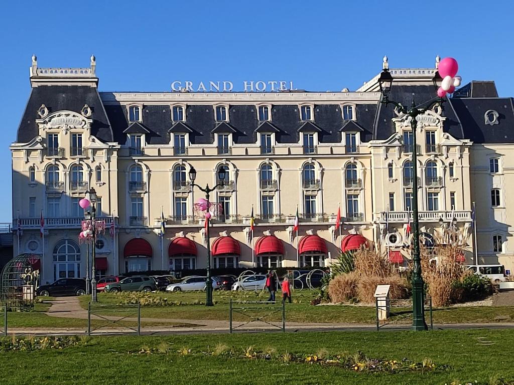 a large building with a grand hotel on top of it at un nid d ' Amour in Cabourg