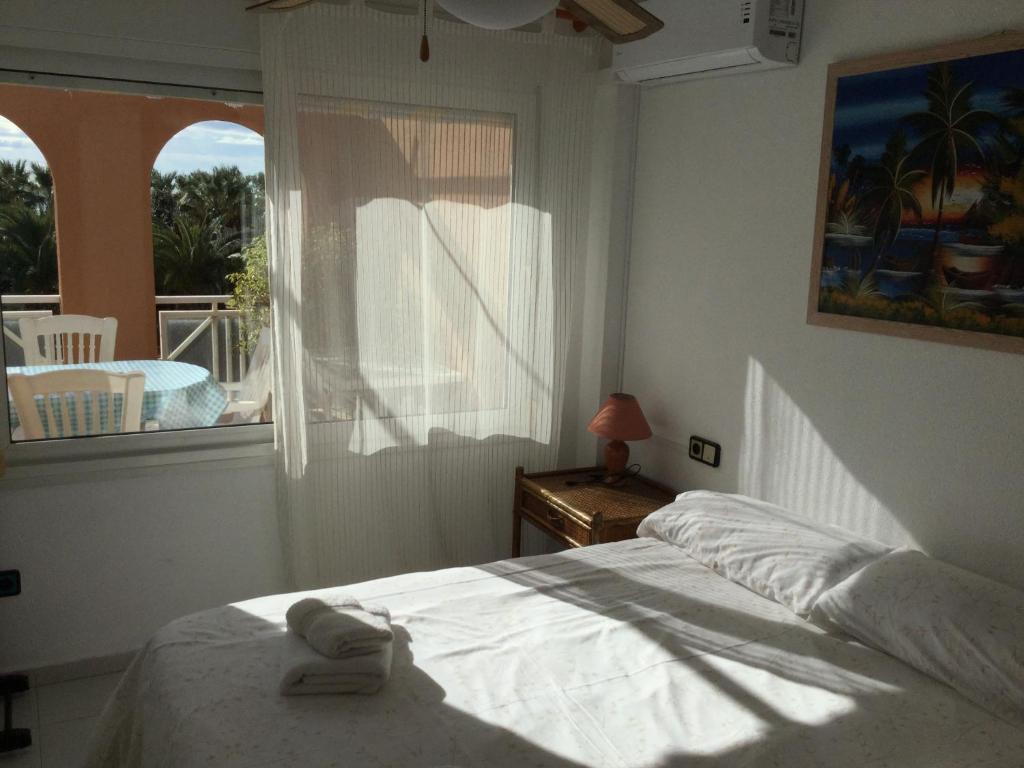 a bedroom with a bed in front of a window at Apartment Kristal Mar in Moraira