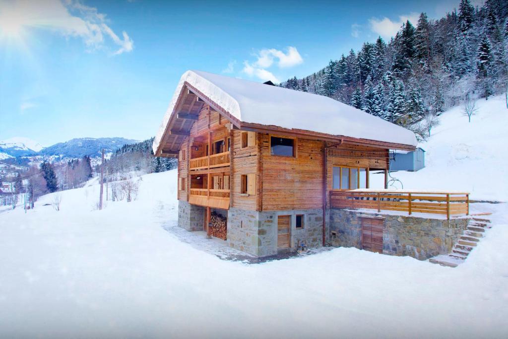 a log cabin in the snow with snow on it at La Ferme du Gran Shan - OVO Network in Les Villards-sur-Thônes