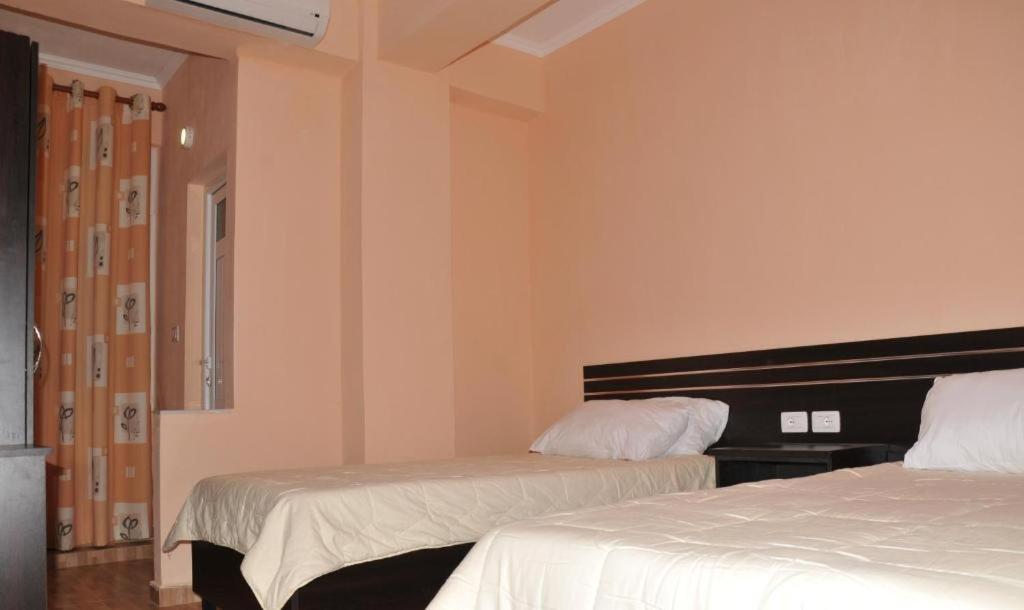 Postel nebo postele na pokoji v ubytování Garden Hotel