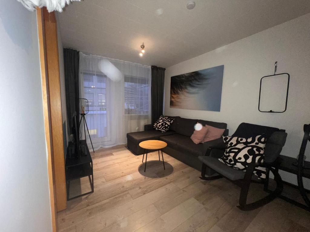 a living room with a couch and a table at Downtown North Apartment in Akureyri