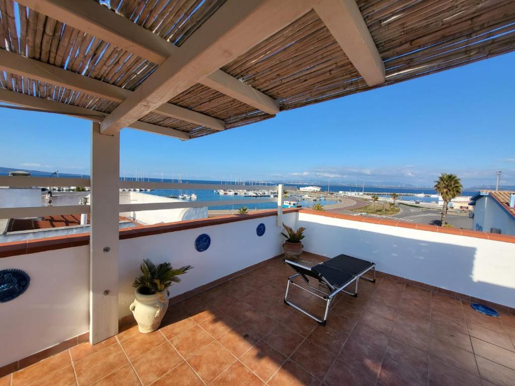 a balcony with a table and a view of the ocean at Perla del mare in Calasetta