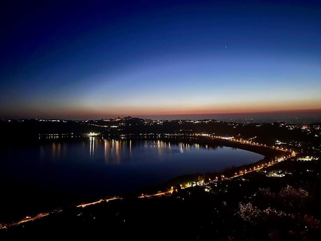 a view of a large lake at night at La Locanda Del Pontefice - Luxury Country House in Castel Gandolfo