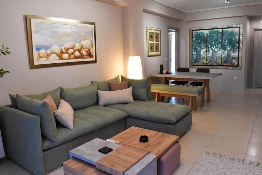 a living room with a couch and a table at Apartment in Peania in Paianía