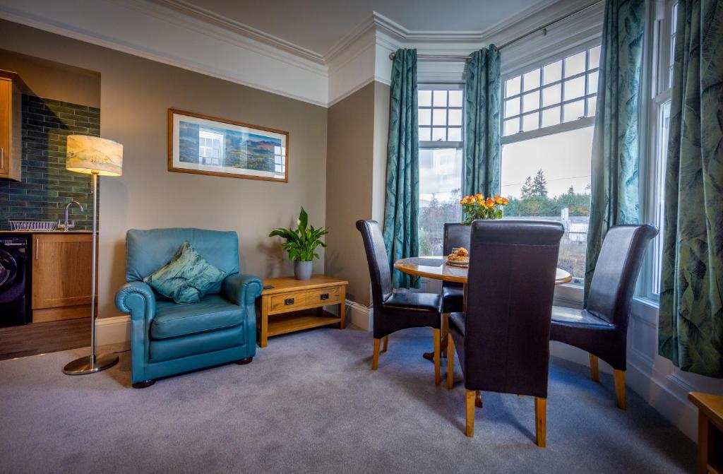 a living room with a table and chairs at Spacious 1st Floor Apartment in Keswick