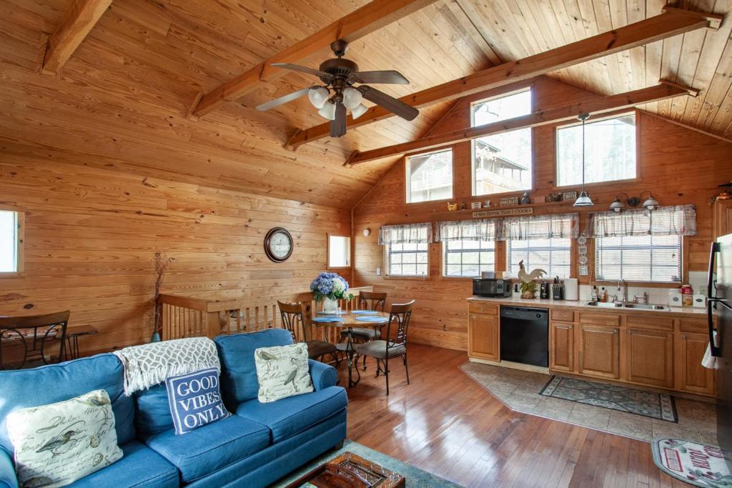 a living room with a blue couch in a cabin at Lovers Paradise Hot Tub Grill Fireplace in Sevierville